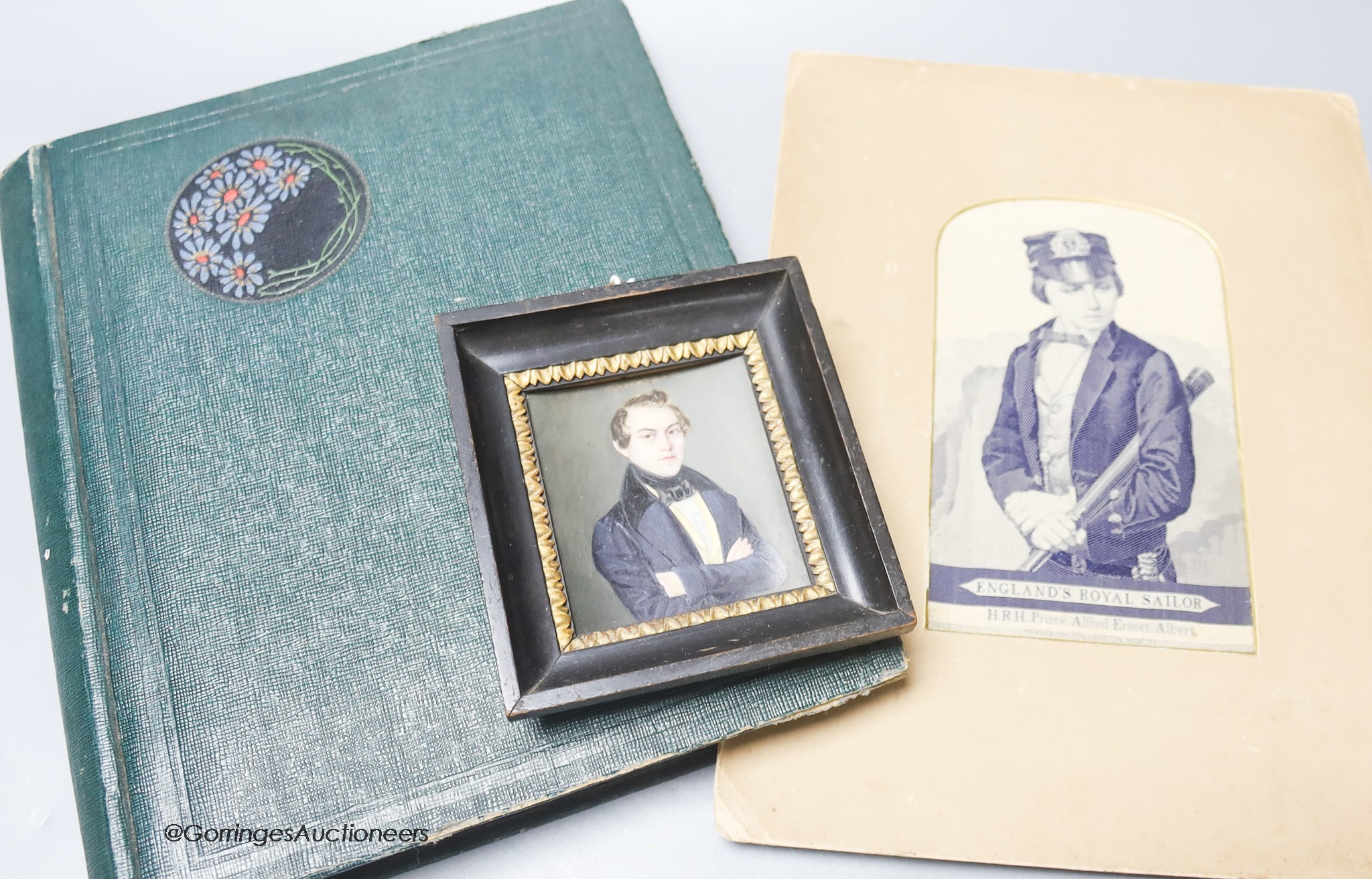 A Stevenograph type portrait album of Royals postcards and a Victorian portrait miniature